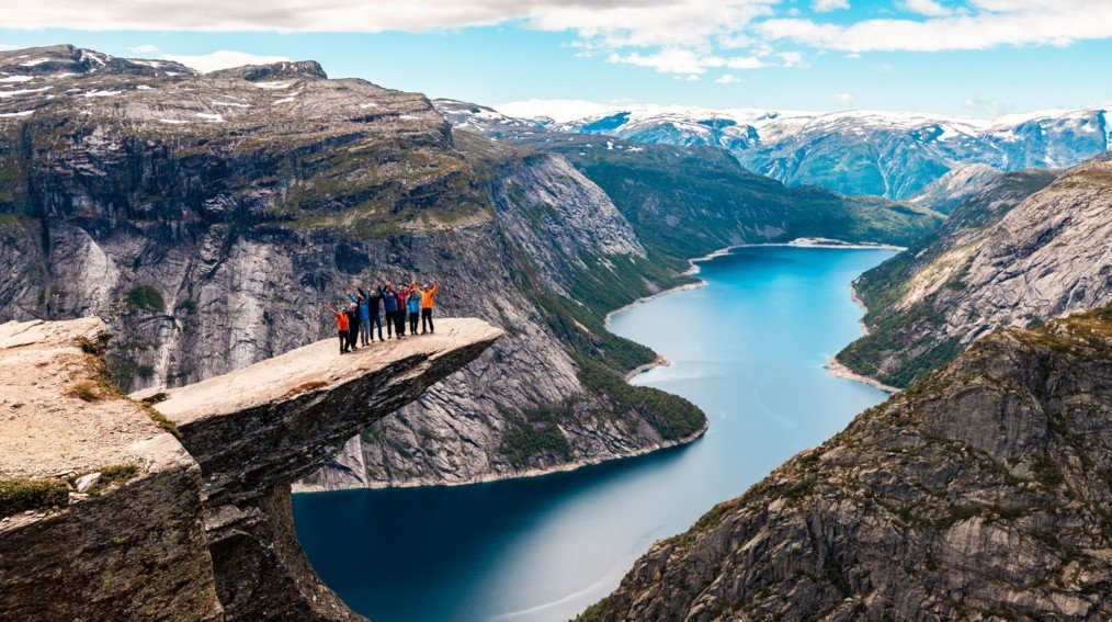 Deep blue fjord surrounded by steep green mountains